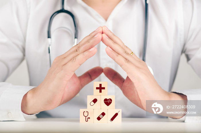 Hand arranging wood block stacking with the healthcare medical icon. Health insurance - health concept