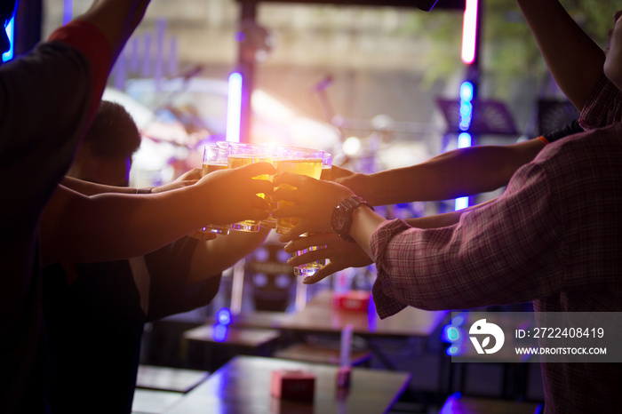 Group of  young people hands toasting and cheering aperitif beers half pint