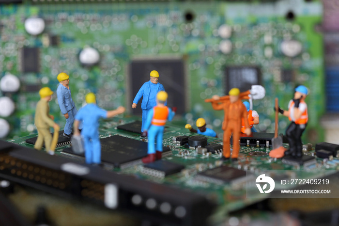 Selective focus of miniature engineer and worker fixed problem chipset of Personal computer (PC) on blurred mainboard background as business and industrial concept.