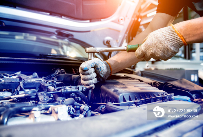 Car mechanic repair engine at service station. Car repair