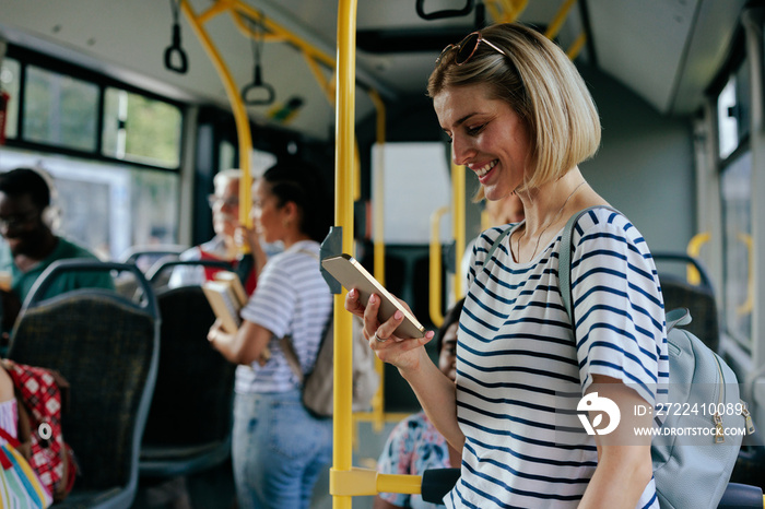 Caucasian woman texting on city bus