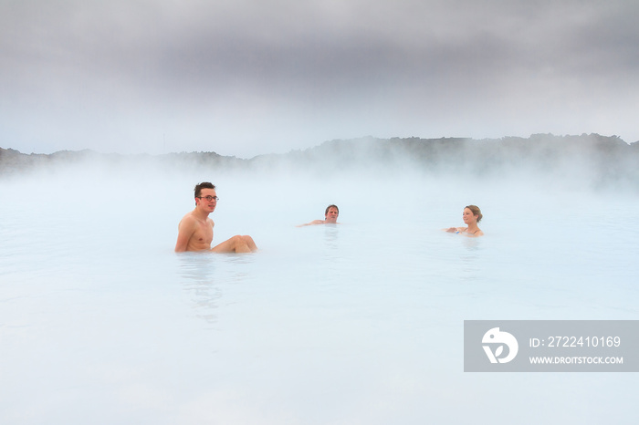 Sick people healing in the blue mineral waters of a geothermal spa in Iceland