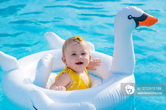 Baby swims in a circle on the sea. Selective focus.