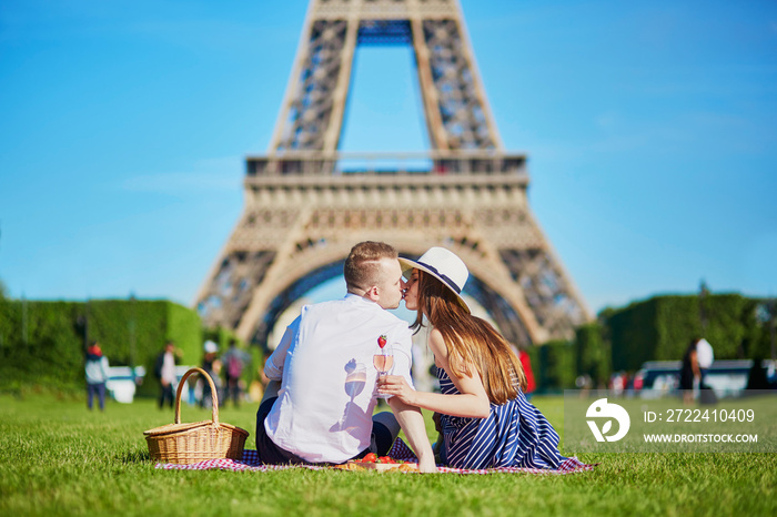 Couple having picnic near the Eiffel tower in Paris, France