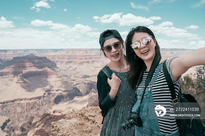 young girls taking selfie standing on the rim