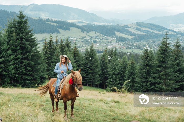 horseback riding from overlooking wide open field and mountains