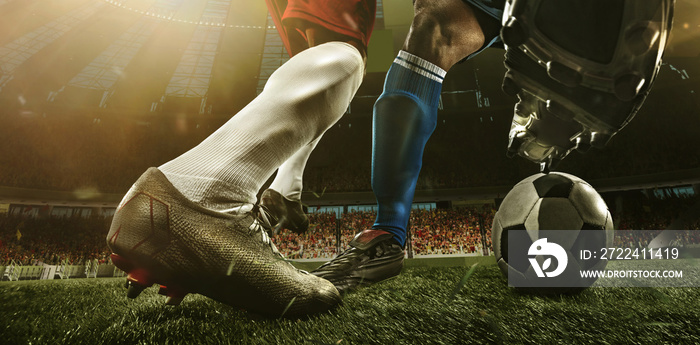 Close-up legs of soccer, football players in action, motion at the stadium with flashlights and crowded stands. Concept of sport, competition, movement, overcoming.