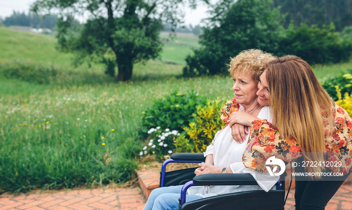 Senior woman in a wheelchair with her daughter