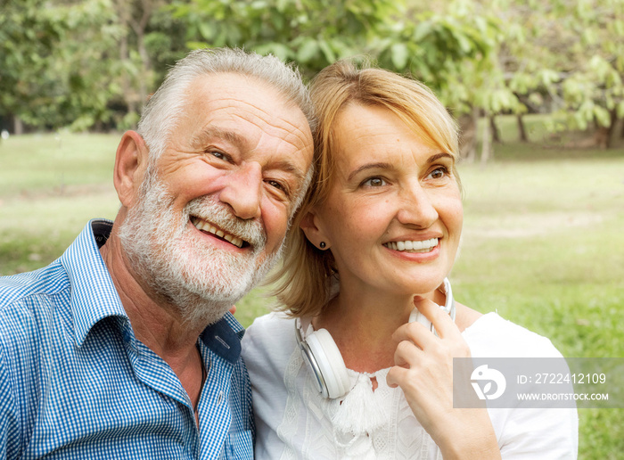 senior couple together enjoying romantic walk in golden park, Happy life