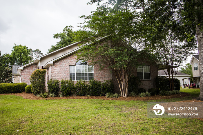 Front of Small Brick House with large yard and curb appeal