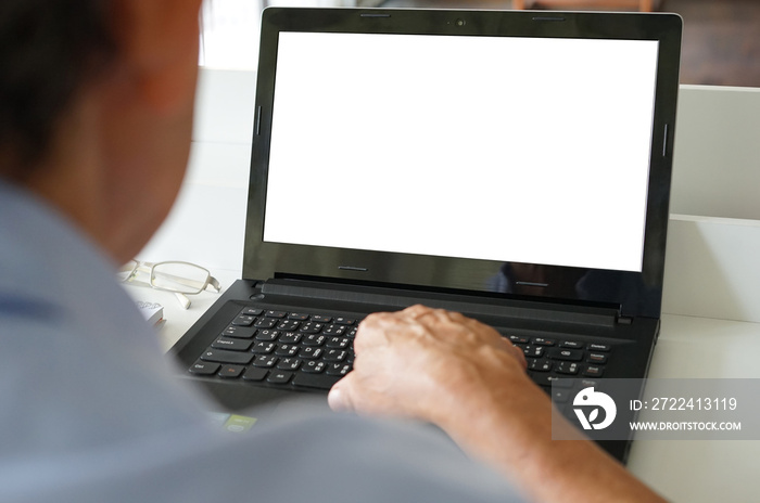 an old man using laptop with white blank screen(selective focus) at home, concept leisure activities in elderly people,lifestyle