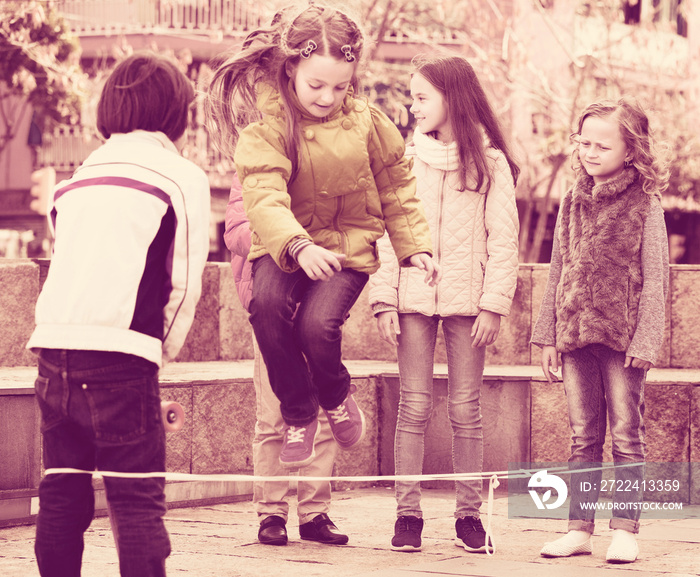 Children playing rubber band jumping