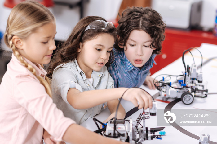 Lively children discussing project at school