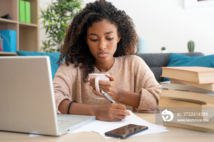 Home education. Black woman watching school lesson from home