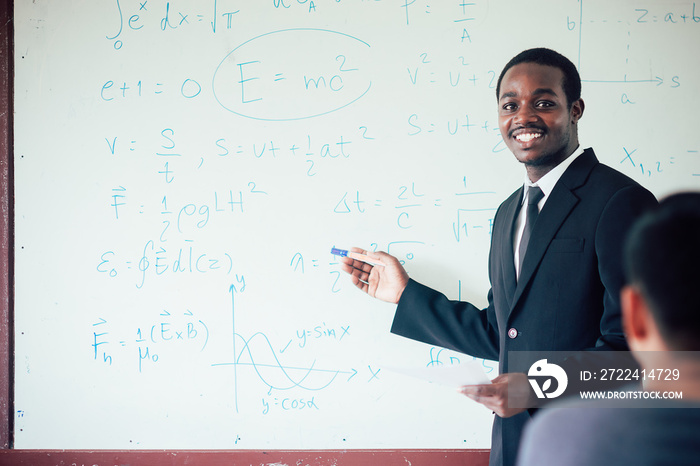 African foreign teacher teaching  science in the classroom.