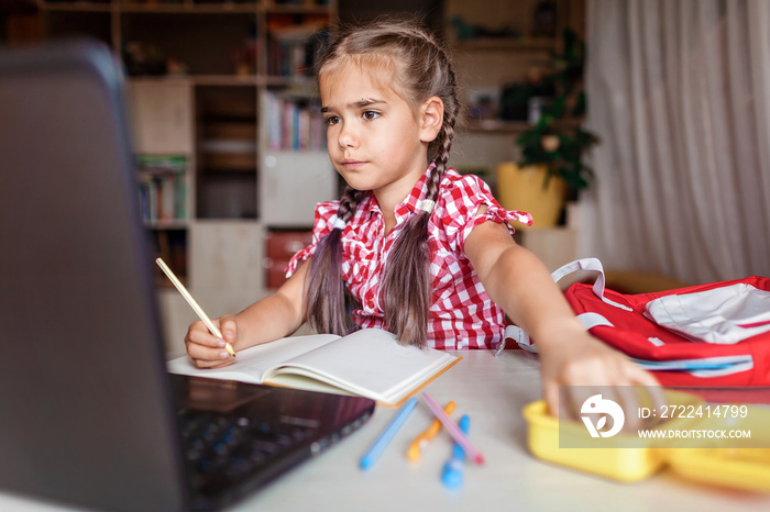 Distant education, back to school. Girl studying homework during online lesson at home