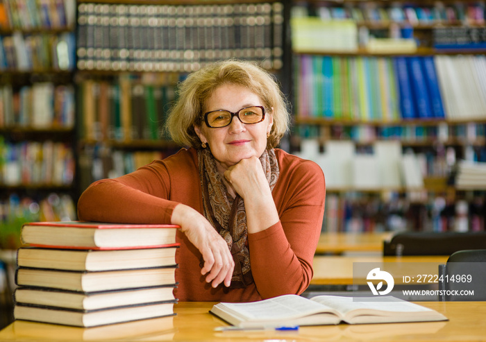 Happy senior woman in library