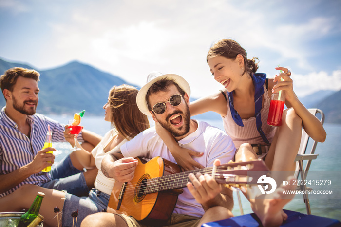 Young people having fun on summer vacation.Happy friends drinking tropical cocktails on the beach.