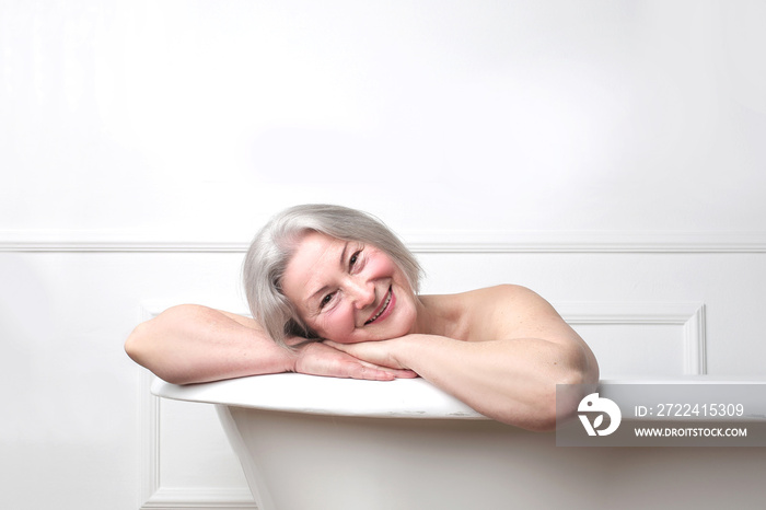 Lady smiling in bath tub