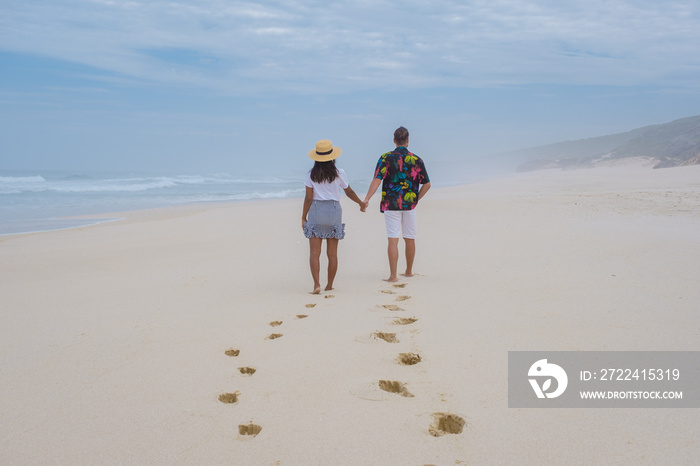 Man and Women walking at the beach De Hoop Nature reserve South Africa Western Cape, beautiful beach of south Africa with the white dunes at the de hoop nature reserve which part of the garden route