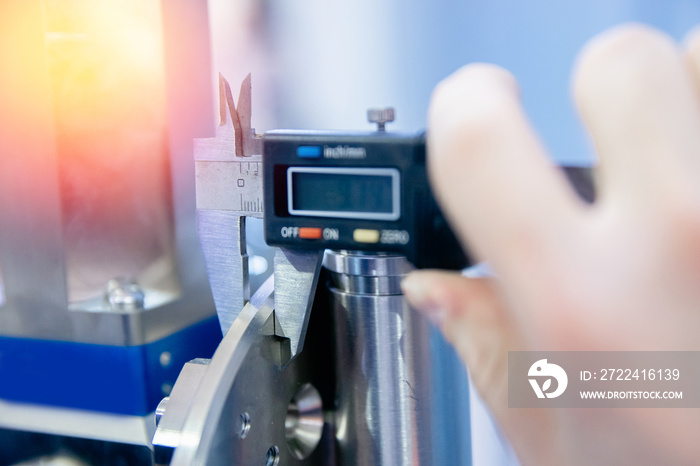 Closeup Engineer checks quality of detail for engine at car manufacturing plant, industry concept