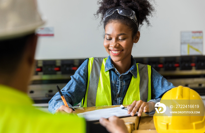 African American worker working in warehouse. Industrial and industrial workers concept. worker woman order details and checking goods and Supplies.