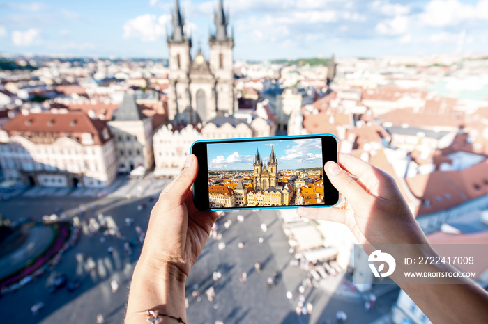 Photographing with smart phone the old town square of Prague