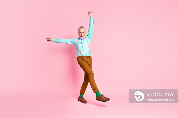 Full length body size photo of granddaddy fooling dancing pointing up smiling wearing bowtie isolated on pink color background