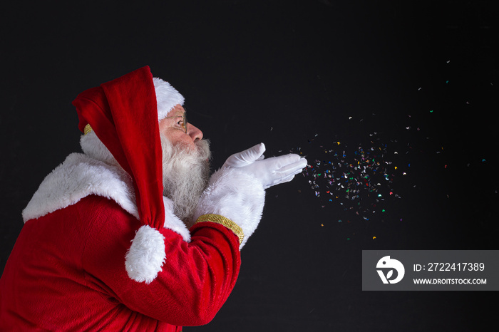 Christmastime traditions. Santa blowing snowflakes.