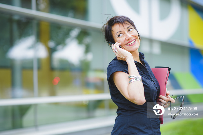 Beautiful middle age business woman talking smiling on mobile cell phone smartphone