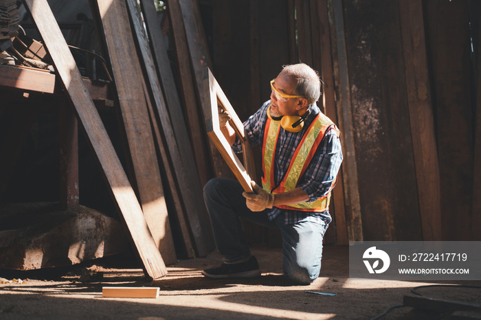 An elderly carpenter works the wood with meticulous care.