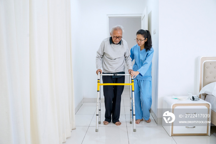 Old man doing physical treatment with nurse