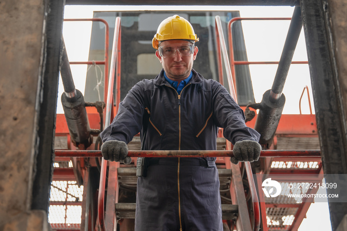 caucasian engineer and heavy machine operator with container forklift at containers yard and cargo