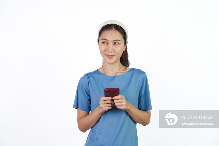 Beautiful Asian woman in blue t-shirt isolated on white background. Holding cellphone