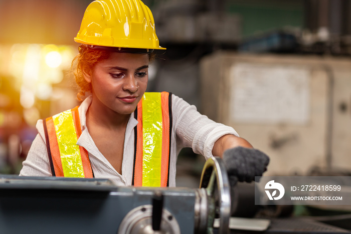 Girl teen worker african american working labor in industry factory with heavy steel machine.