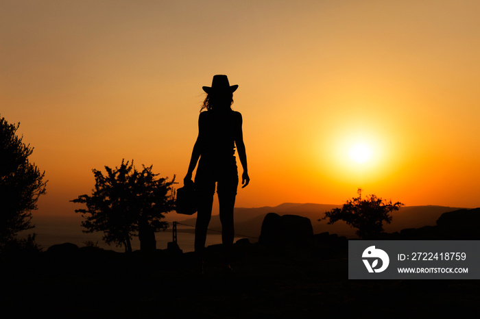 Silhouette capture of a woman wearing cowboy hat