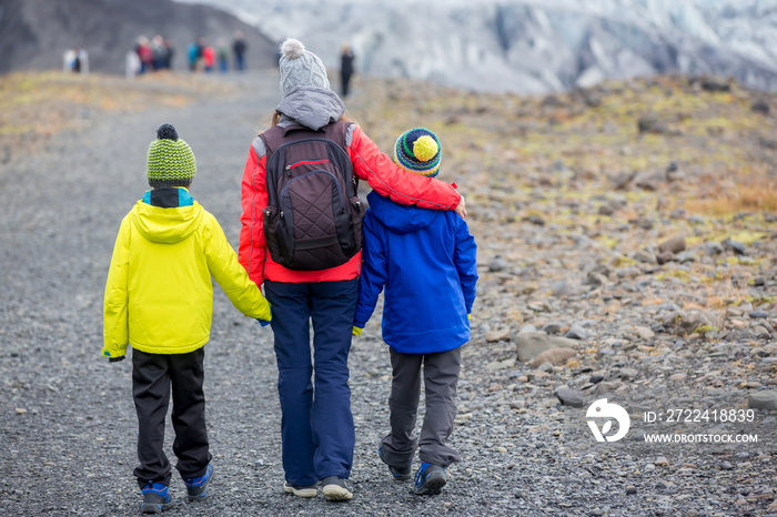 Mother walking with two boys, in beautiful aerial view of the nature in Skaftafell Glacier national park on a gorgeous autumn day