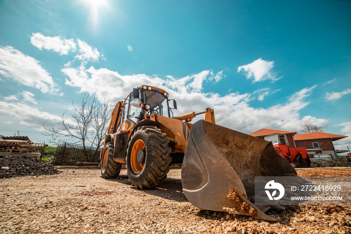 Yellow bulldozer excavator on the construction site working machine