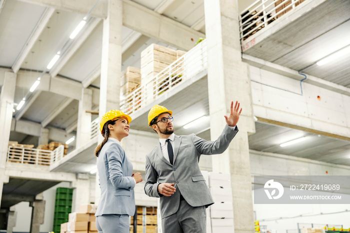 Businessman showing around factory to his business partner.