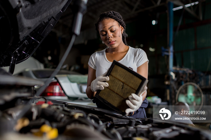 Mechanic is checking and change an air filter. Car mechanic working maintenance checking air filter in repair garage.