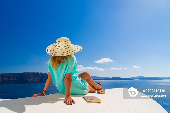 Luxury travel vacation woman looking at view on Santorini island