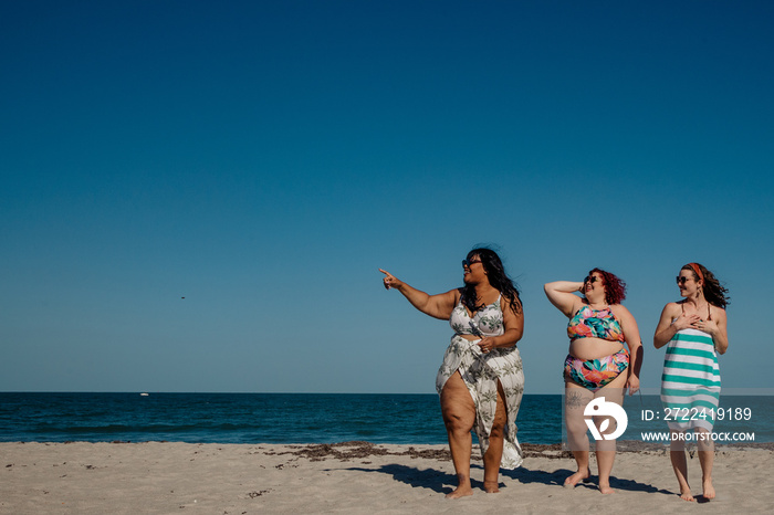 3 women walk on the beach