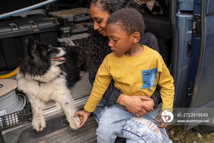 Mother with son and dog in van preparing for trip