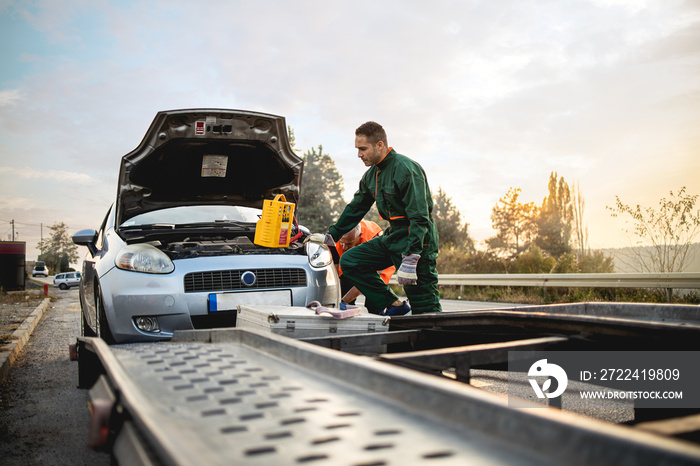 Repairer, transports a broken car on the road.Stock photo