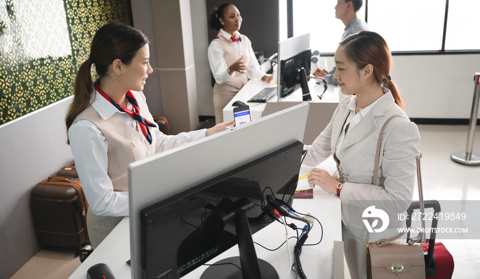 Airlines with check-in counters with passenger businesswoman at airport