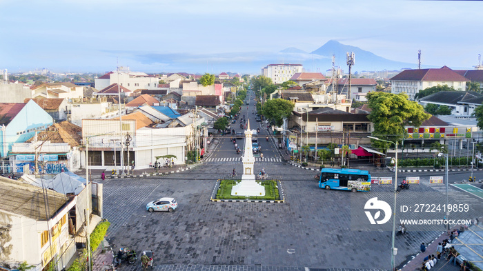 Tugu Yogyakarta with mount under blue sky