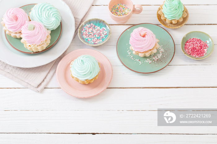 cupcakes on plates on white wooden background