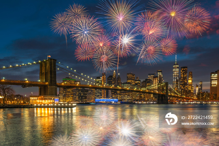 Multicolor Firework Celebration over scene of New york Cityscape with Brooklyn Bridge over the east river at the twilight time, USA downtown skyline, 4th of July and Independence day concept