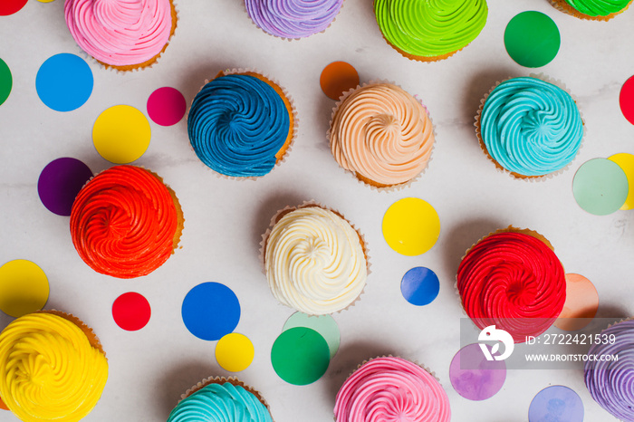 Colourfull rainbow cupcakes with confetti flat lay