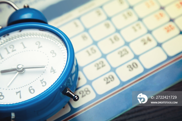 Blue alarm clock with calendar.